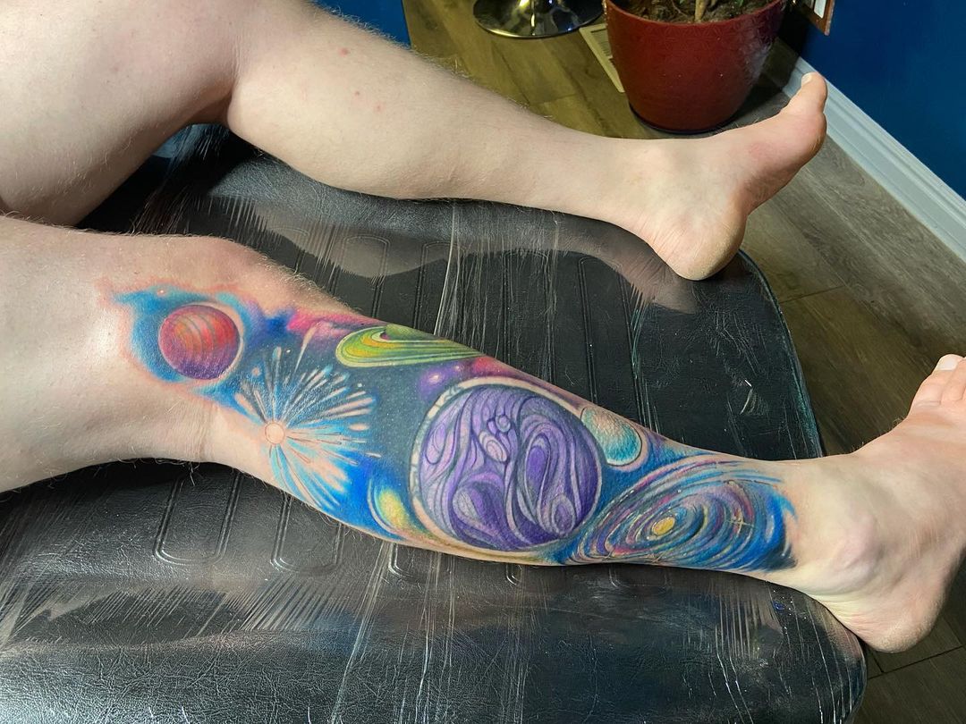 Water color tattoo of space galaxy on leg