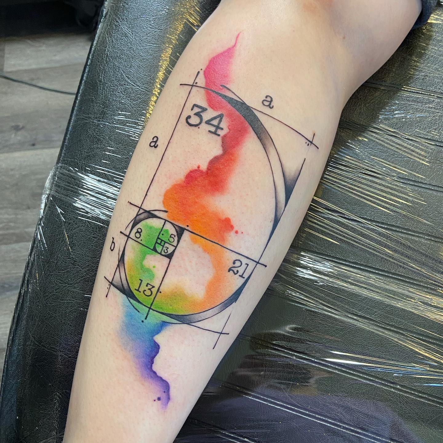 Water color tattoo of Fibonacci spiral